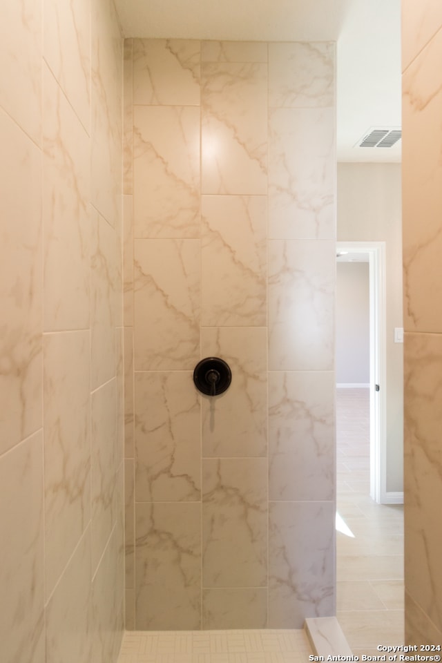 bathroom with a tile shower