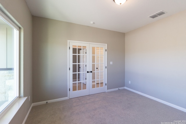 unfurnished room with french doors and carpet floors