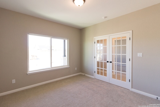 spare room with french doors and carpet floors