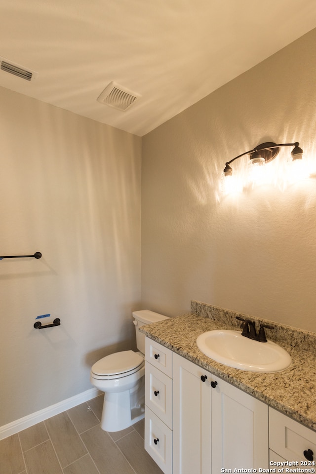 bathroom with vanity and toilet