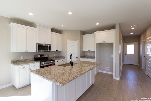 kitchen featuring white cabinetry, sink, an island with sink, and appliances with stainless steel finishes