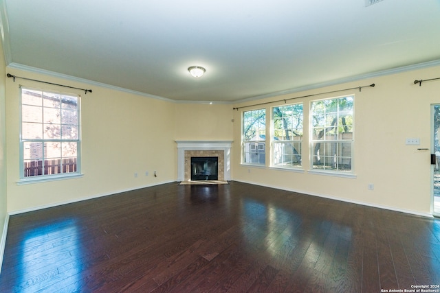 unfurnished living room featuring plenty of natural light, dark hardwood / wood-style flooring, and a fireplace