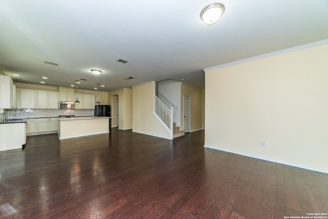 unfurnished living room with dark hardwood / wood-style floors and ornamental molding