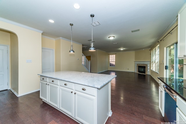 kitchen with a center island, dark hardwood / wood-style flooring, and white cabinetry