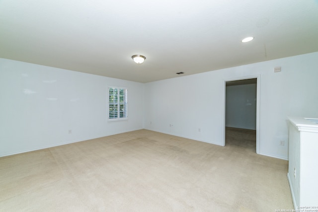 unfurnished room with light colored carpet