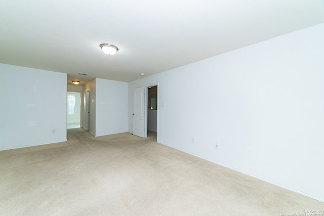 empty room featuring light carpet