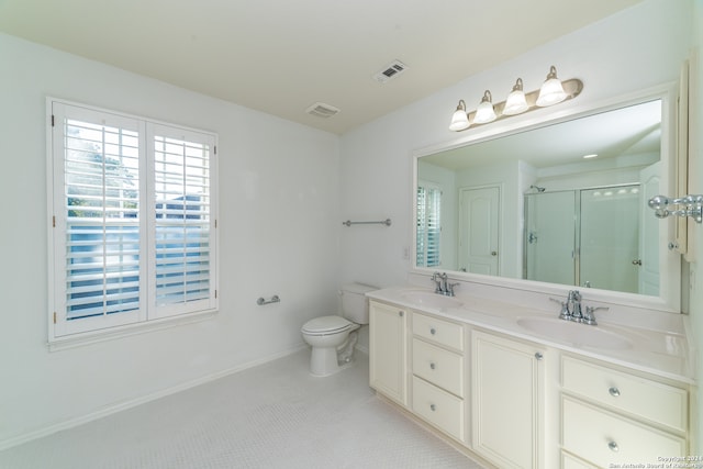 bathroom with vanity, an enclosed shower, and toilet