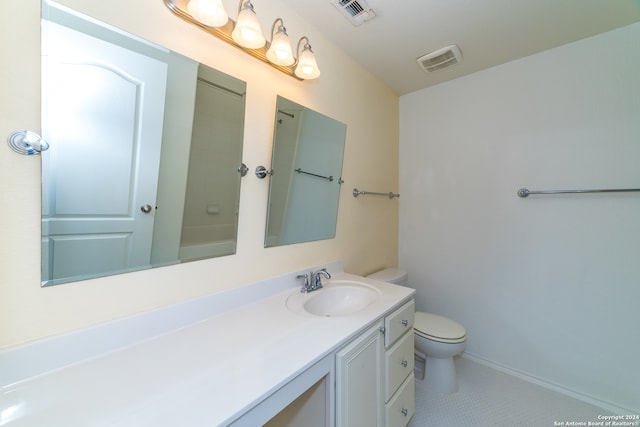 bathroom featuring tile patterned flooring, vanity, and toilet