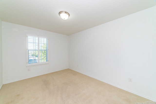 empty room featuring light carpet