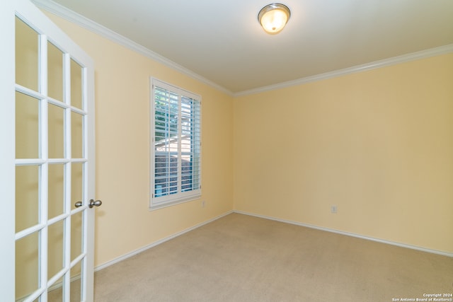 unfurnished room with light carpet and crown molding