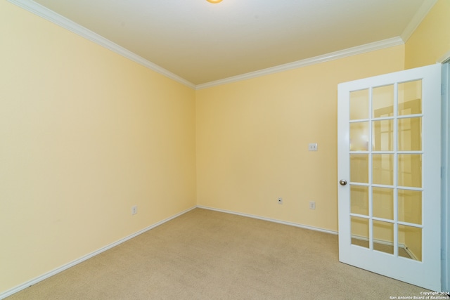 spare room featuring crown molding, french doors, and carpet floors