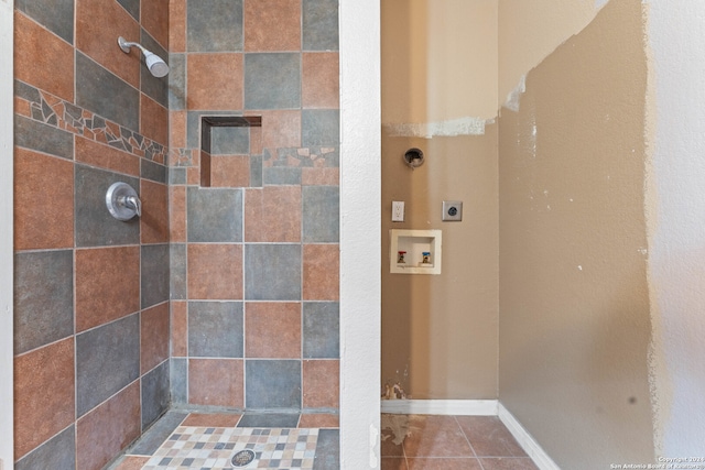 bathroom featuring tile patterned flooring and tiled shower