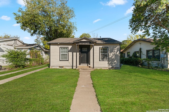 bungalow-style house with a front lawn