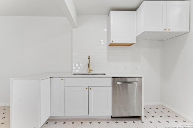 611 Kirk Pl, San Antonio, TX 78225 - kitchen with a sink, stainless steel dishwasher, white cabinetry, tasteful backsplash, and baseboards
