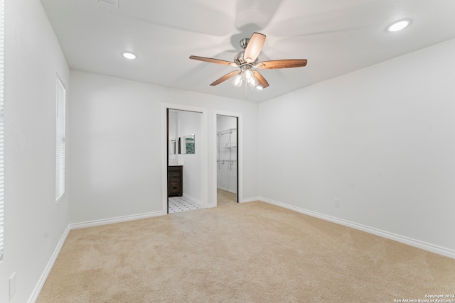 unfurnished bedroom with ceiling fan and light carpet