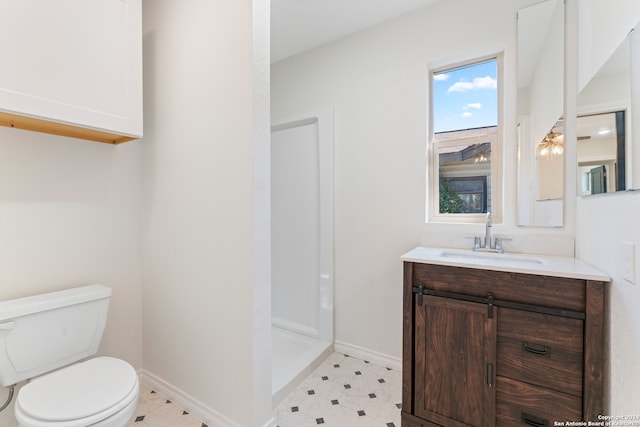 bathroom featuring vanity, toilet, and walk in shower