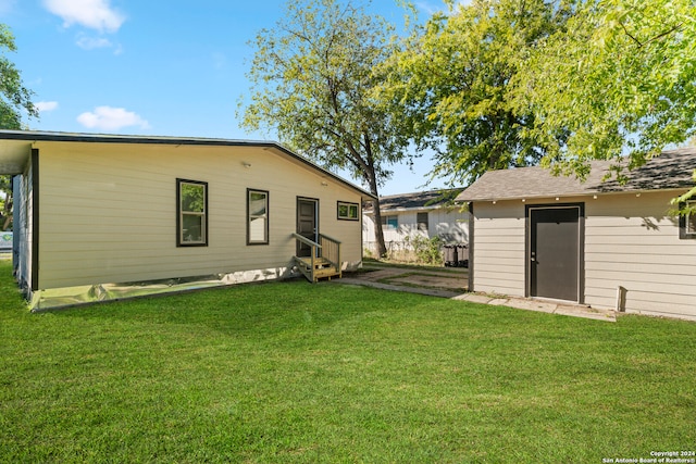 rear view of property with a lawn