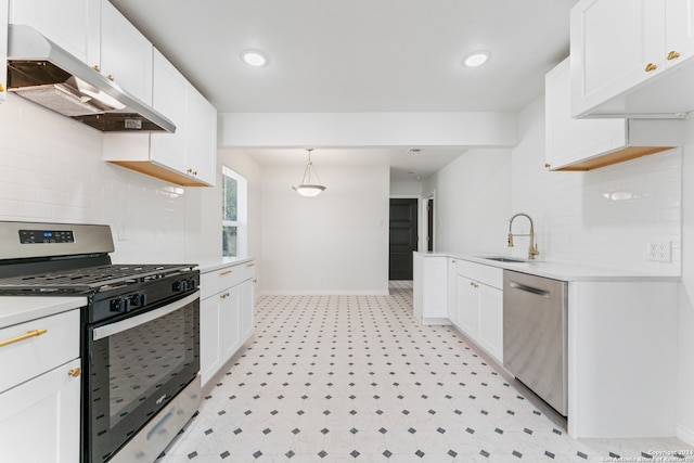 kitchen featuring pendant lighting, white cabinetry, stainless steel appliances, and range hood