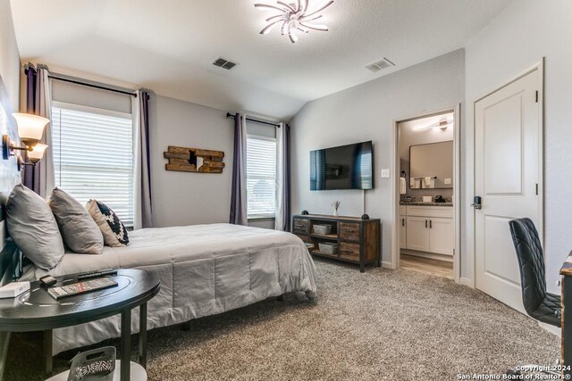 7544 Magnolia Vlg, San Antonio, TX 78252 - bedroom featuring lofted ceiling, light colored carpet, and ensuite bathroom