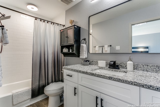 full bathroom with hardwood / wood-style flooring, vanity, shower / bath combination with curtain, and toilet