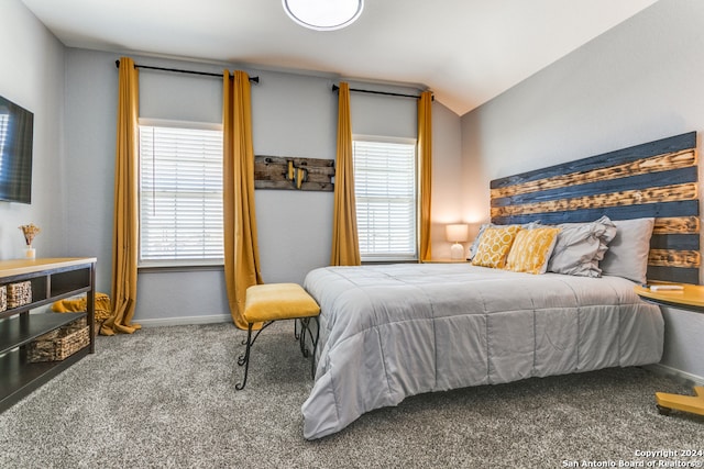 carpeted bedroom featuring multiple windows and vaulted ceiling