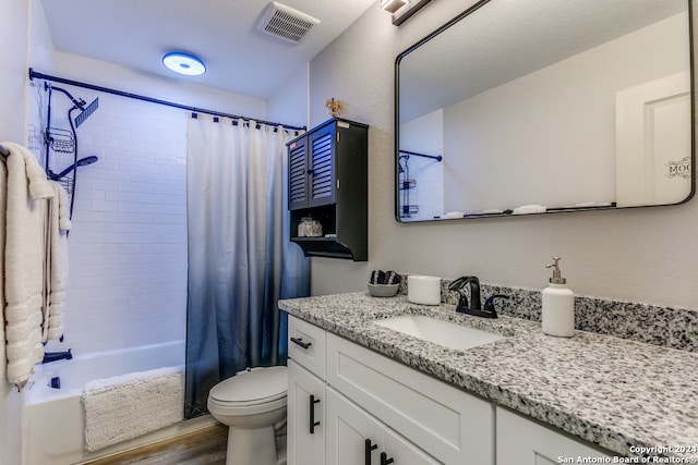 full bathroom featuring hardwood / wood-style flooring, vanity, toilet, and shower / tub combo with curtain