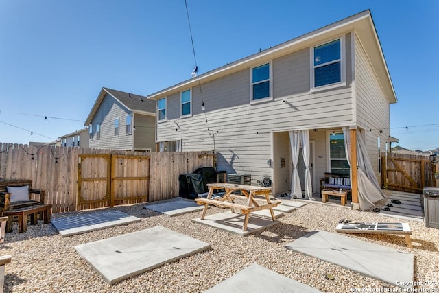 7544 Magnolia Vlg, San Antonio, TX 78252 - back of house with a patio area, a fenced backyard, and central AC