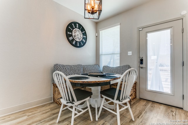 dining area featuring light hardwood / wood-style floors and a chandelier