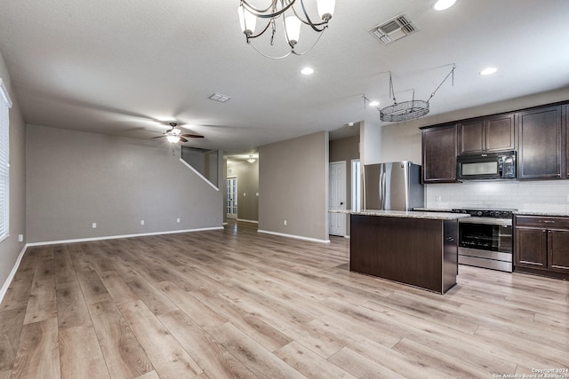 11902 Silver Horse, San Antonio, TX 78254 - kitchen with stainless steel appliances, a center island, dark brown cabinets, decorative backsplash, and light wood-type flooring