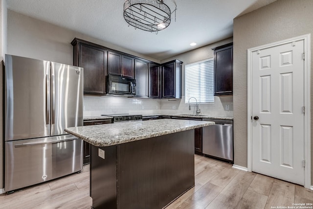 11902 Silver Horse, San Antonio, TX 78254 - kitchen featuring appliances with stainless steel finishes, a sink, light wood-style floors, tasteful backsplash, and recessed lighting