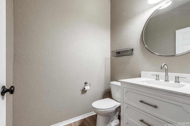 11902 Silver Horse, San Antonio, TX 78254 - half bathroom with wood finished floors, vanity, toilet, a textured wall, and baseboards