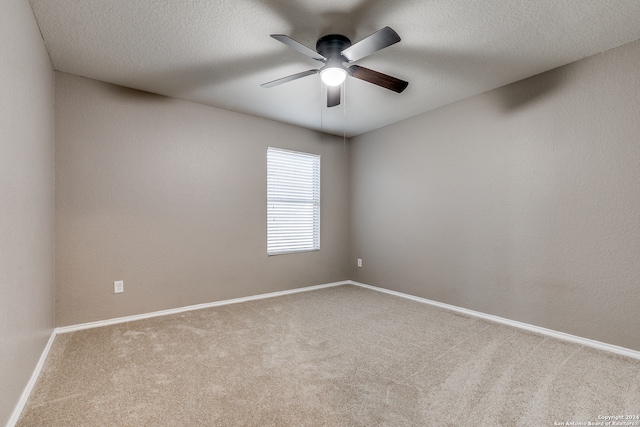 unfurnished room with carpet flooring, a textured ceiling, and ceiling fan