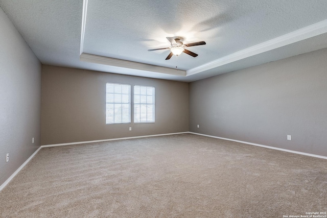 11902 Silver Horse, San Antonio, TX 78254 - spare room with a ceiling fan, a tray ceiling, carpet, a textured ceiling, and baseboards