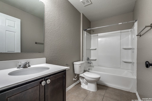 full bathroom featuring tile patterned floors, bathtub / shower combination, vanity, a textured ceiling, and toilet