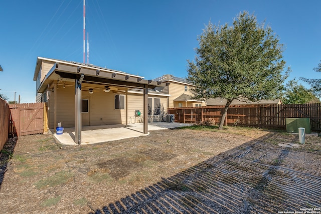 rear view of house featuring ceiling fan and a patio