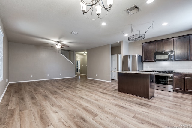 kitchen with light hardwood / wood-style flooring, decorative backsplash, appliances with stainless steel finishes, a kitchen island, and dark brown cabinetry