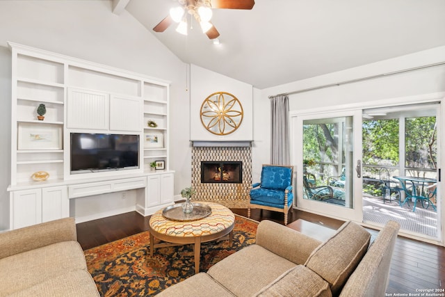 living room featuring hardwood / wood-style floors, vaulted ceiling with beams, ceiling fan, and a tiled fireplace