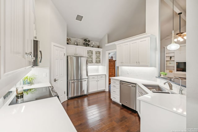 kitchen with pendant lighting, dark wood-type flooring, sink, white cabinetry, and stainless steel appliances