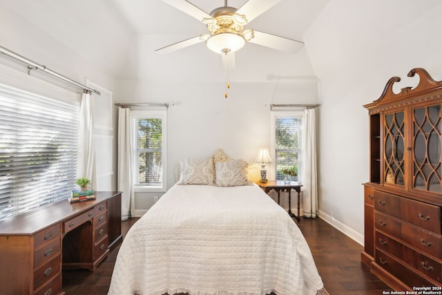 bedroom with dark hardwood / wood-style floors, multiple windows, lofted ceiling, and ceiling fan