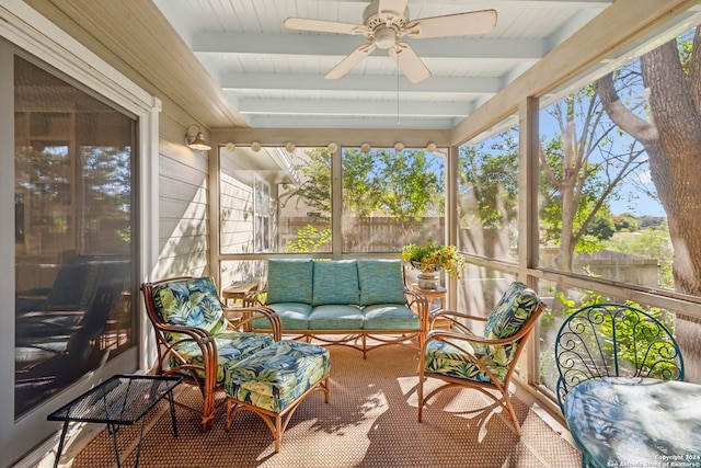 sunroom with ceiling fan, beamed ceiling, and a healthy amount of sunlight