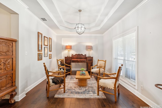 sitting room with dark hardwood / wood-style flooring, ornamental molding, a wealth of natural light, and an inviting chandelier