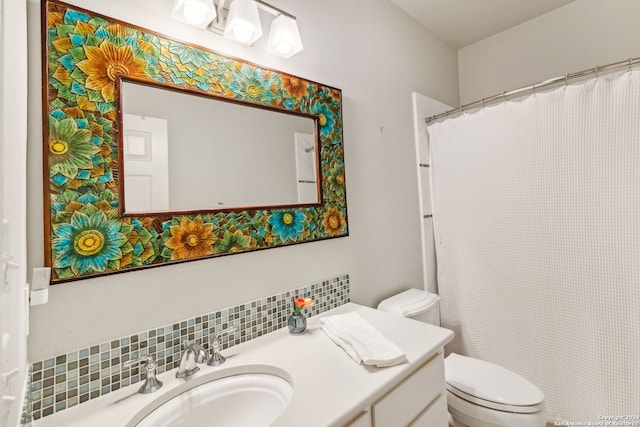 bathroom featuring decorative backsplash, vanity, and toilet