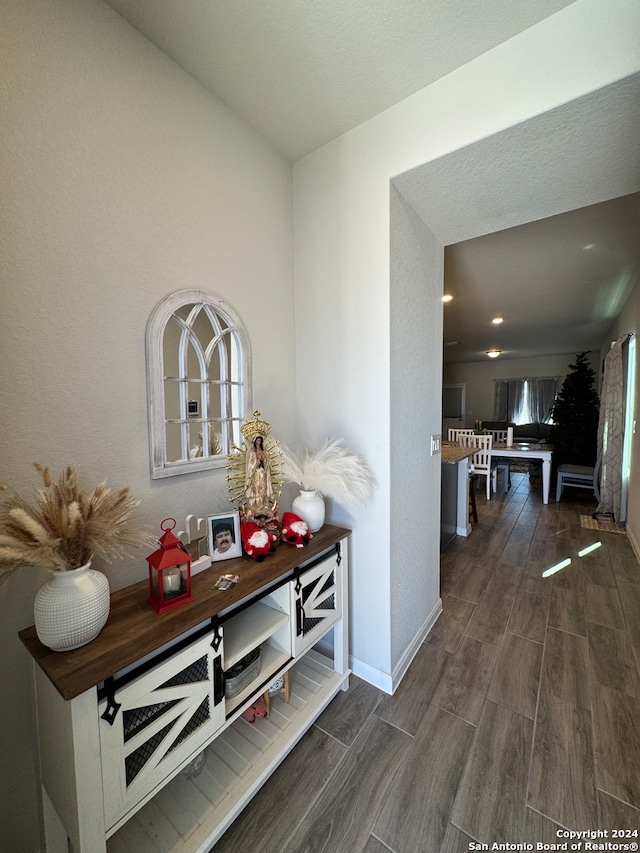 hallway with dark hardwood / wood-style flooring