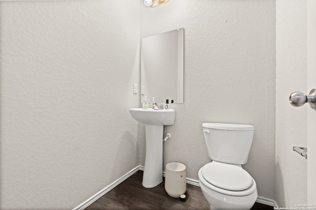 bathroom with sink, toilet, and hardwood / wood-style flooring