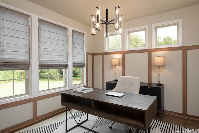 home office featuring a healthy amount of sunlight and an inviting chandelier