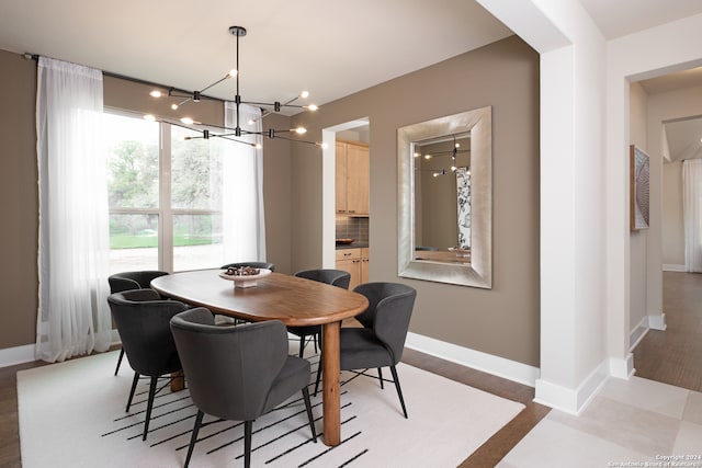 dining space featuring hardwood / wood-style flooring and a notable chandelier