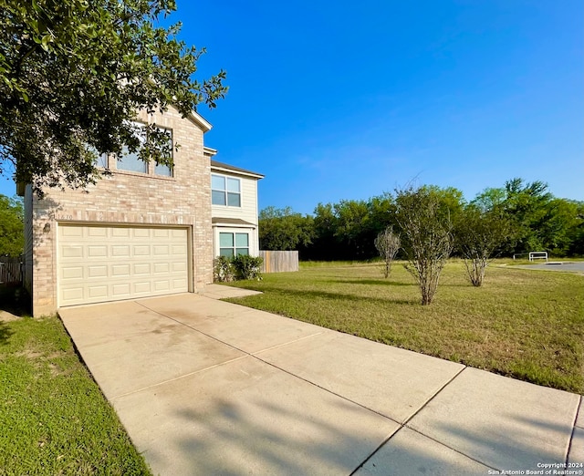 view of front of house with a garage and a front yard