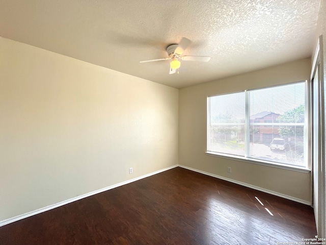 unfurnished room with a textured ceiling, ceiling fan, and dark wood-type flooring