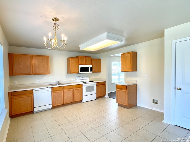 kitchen featuring sink, a notable chandelier, decorative light fixtures, white appliances, and light tile patterned flooring