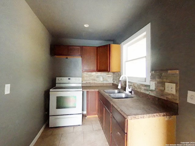 kitchen featuring white range with electric stovetop, light tile patterned flooring, decorative backsplash, and sink